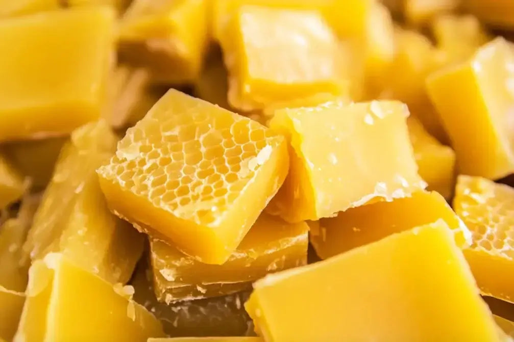 Close-up of yellow beeswax blocks with honeycomb texture