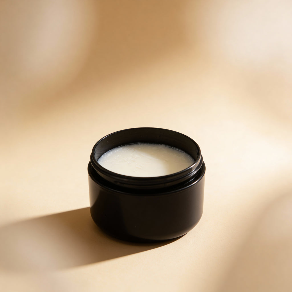 Black jar with white tallow balm on a beige background